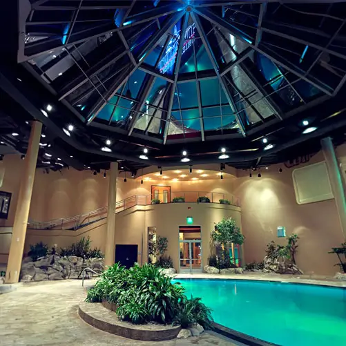 A picture of the pool and the stairs down from the second floor.