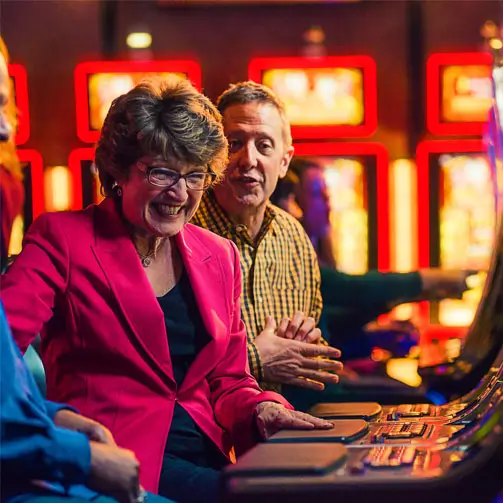 An image of happy people playing slots machines at bingo halls