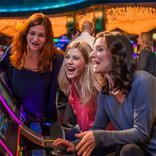 Women playing at a slot machine