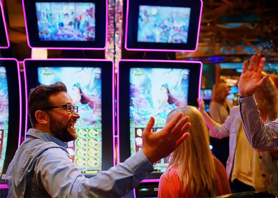 An image of several guests around slot machines.